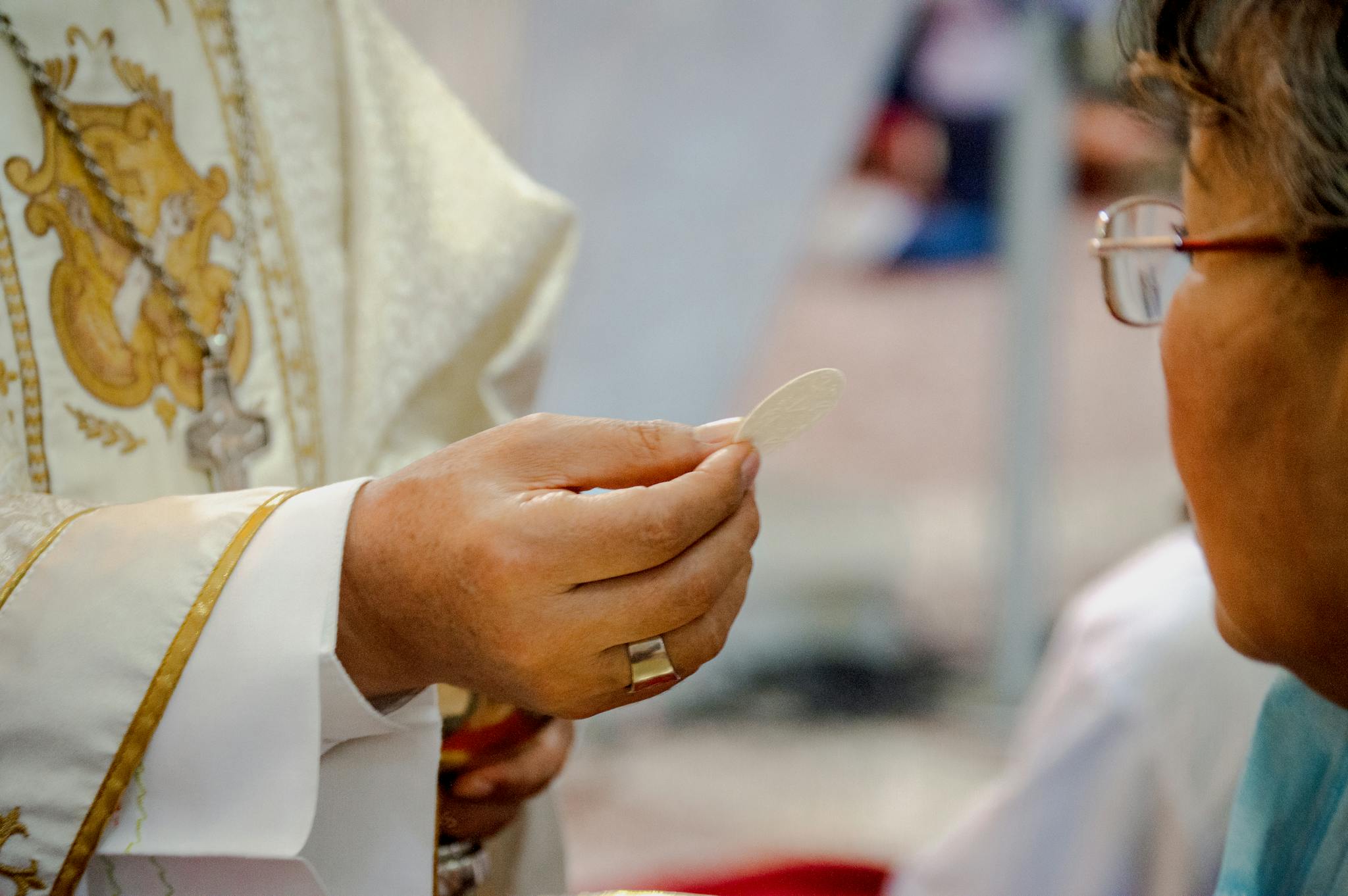 Close-up of a priest offering Holy Communion to a participant in Guayaquil, Ecuador.
